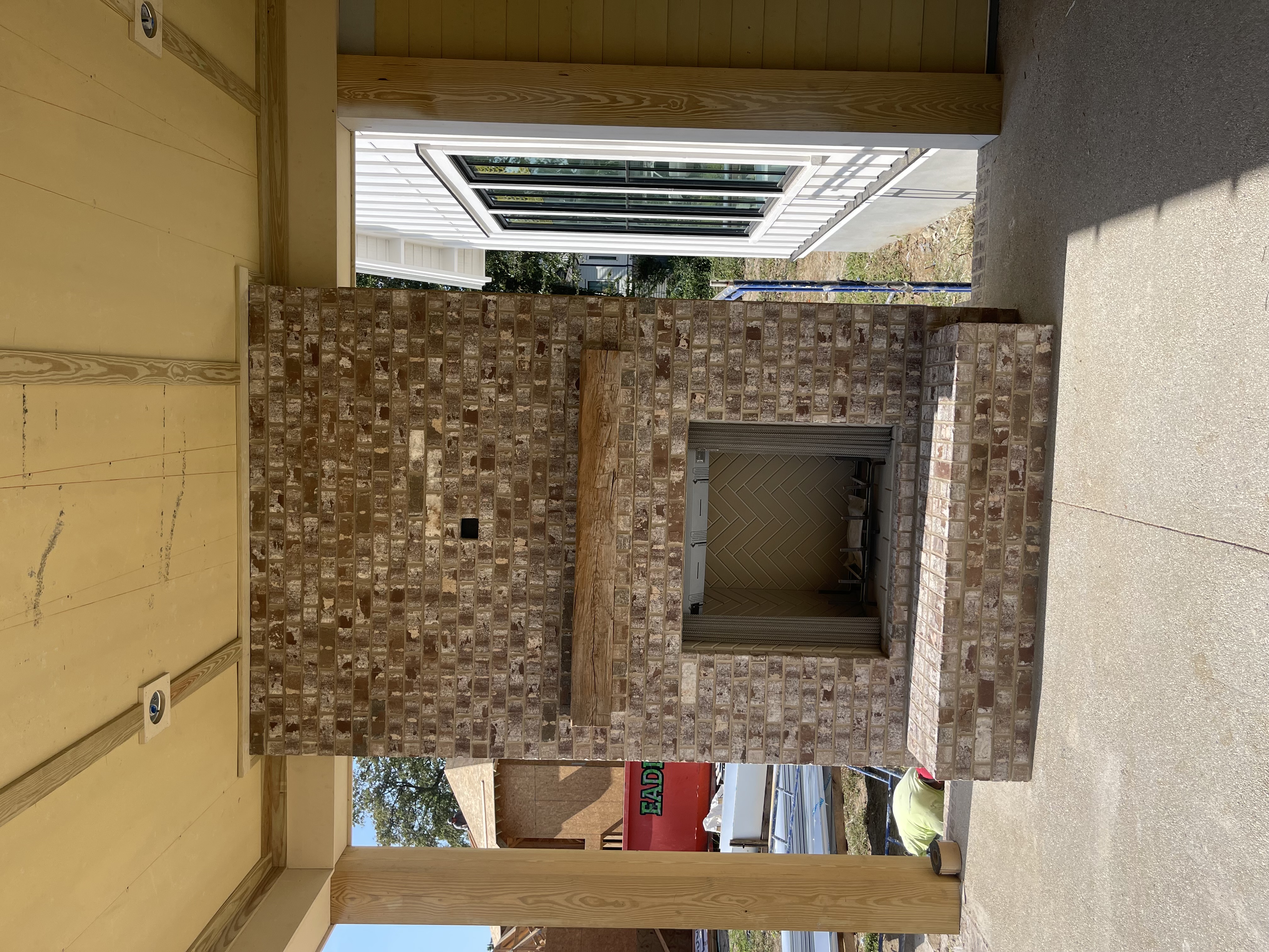 Custom stone mosaic fireplace surround on covered porch