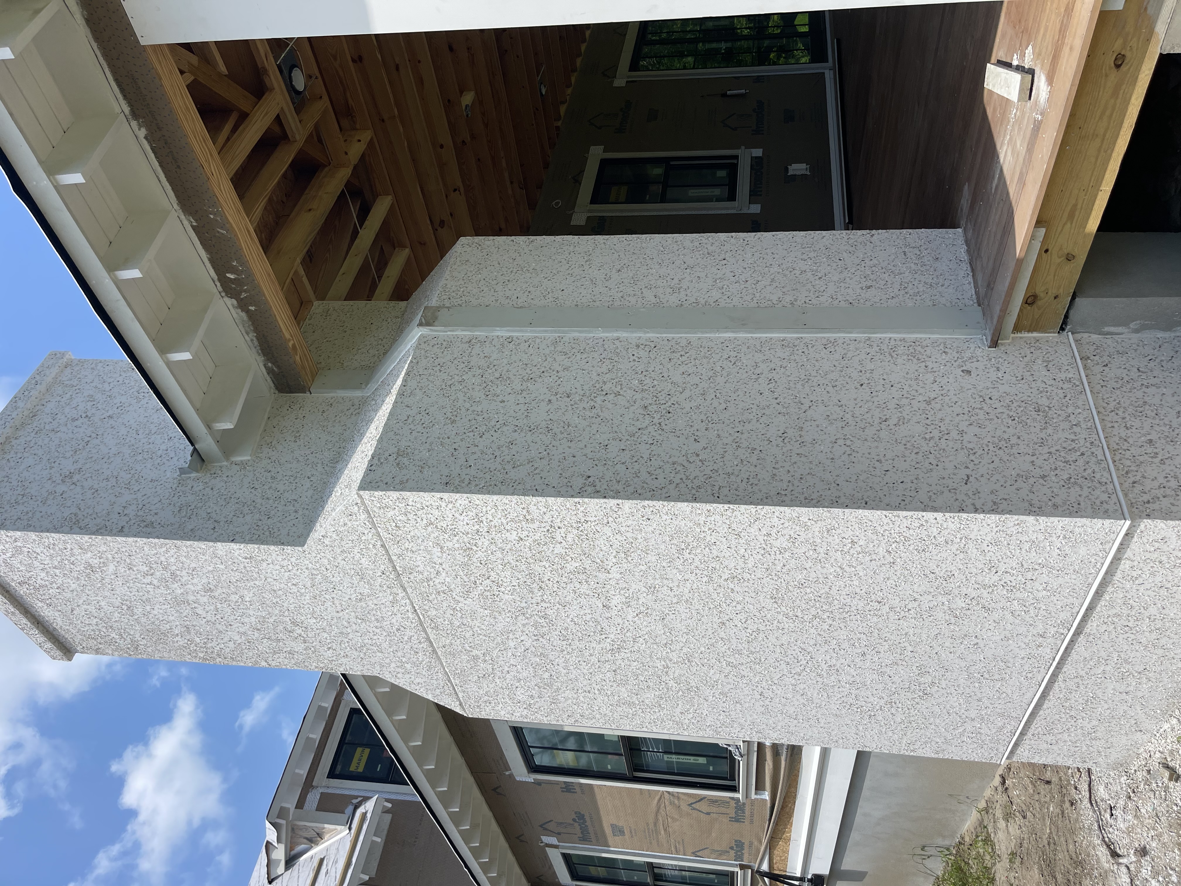 Smooth stucco finish on exterior columns and walls